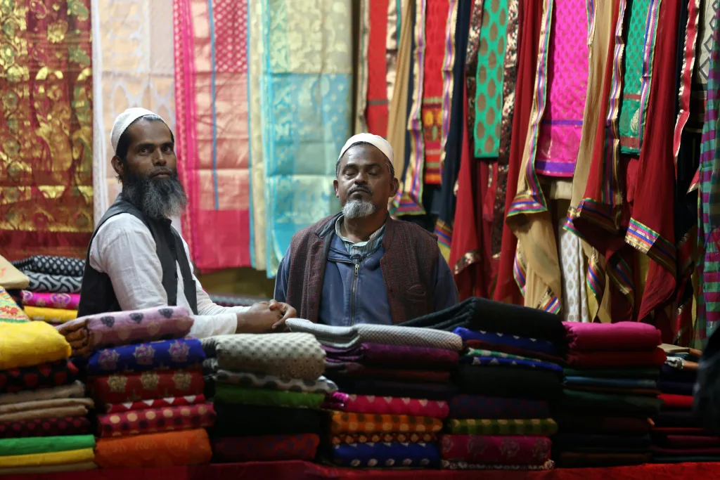 2 men selling clothes in the market - Amritsar Airport Shopping | Oceans Travel