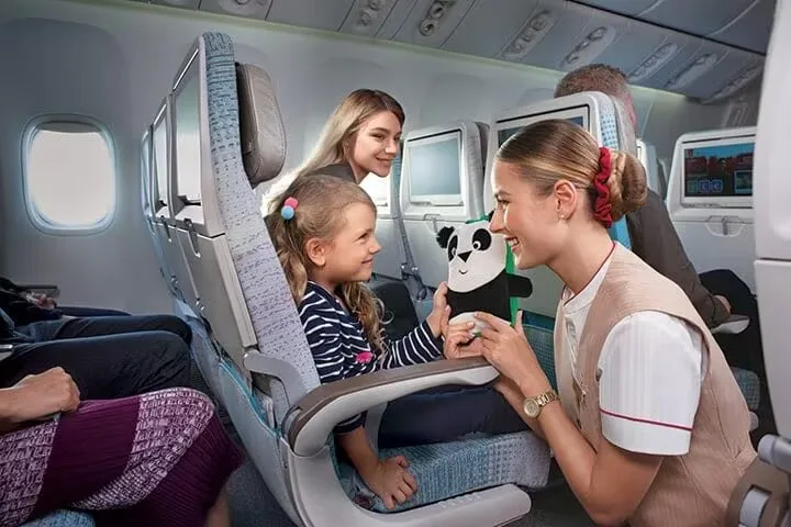 Child Getting a Toy - Amenities - Economy Class | Oceans Travel Blog